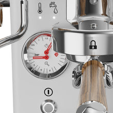 Close-up Lelit Manometer coffee machine with a wooden filter and pressure gauge.
